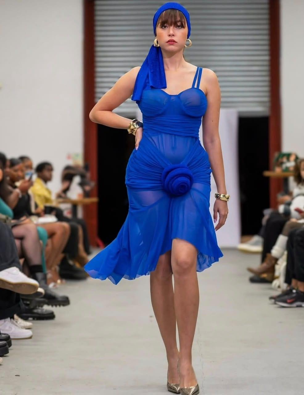 Cobalt halter gown with a feathered pompom detail and matching headpiece, runway