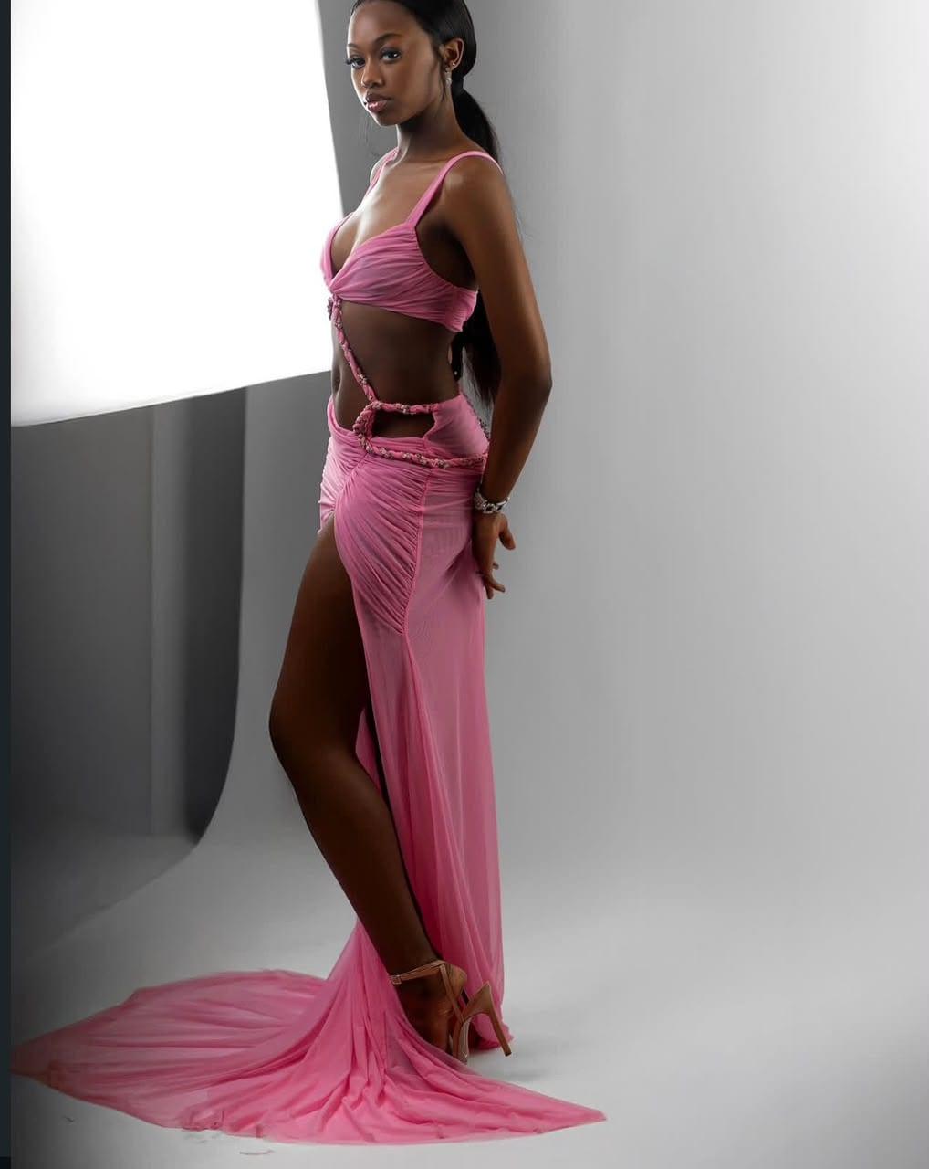 Blush pink cutout gown with a sweeping train, side profile
