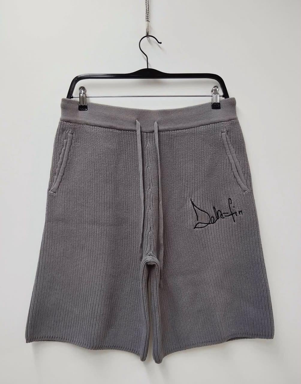 Grey knit shorts with embroidered Dela-Fin script logo, on hanger