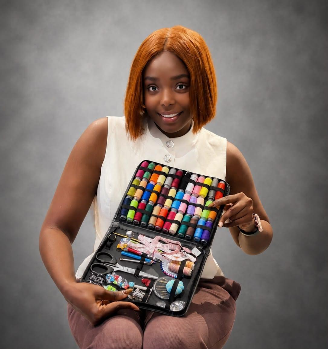Adora Vanessa Mofunanya smiling while presenting her sewing kit