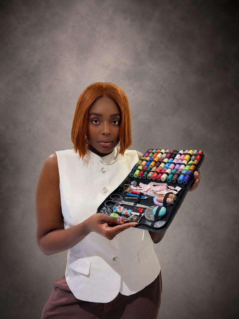 Adora Vanessa Mofunanya holding an open thread and notions case
