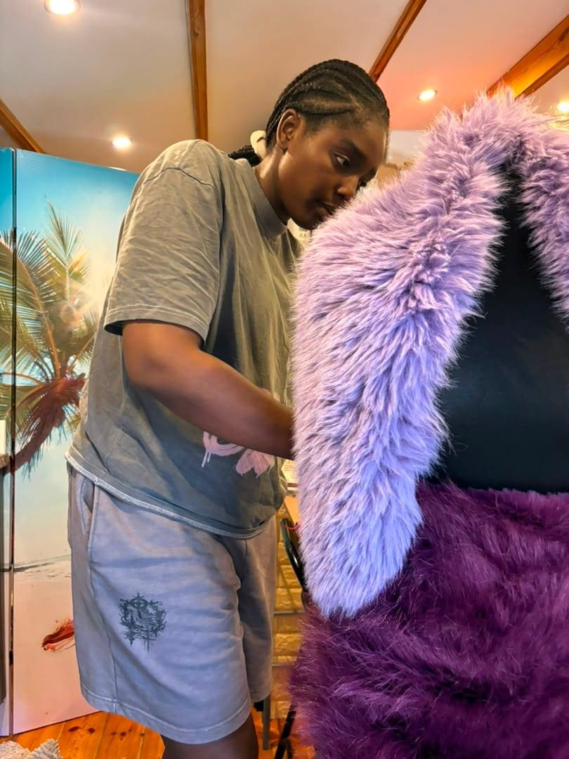 Adora Vanessa Mofunanya draping lilac faux fur over a dress form